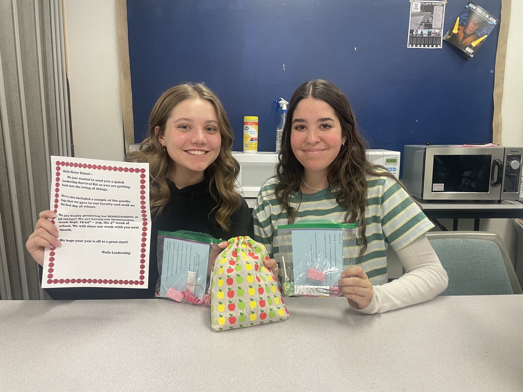 Two students holding gifts received from sister school