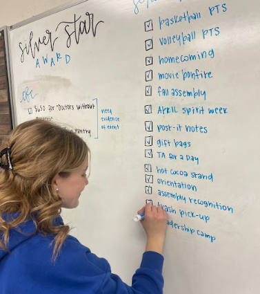 student marking off items on checklist